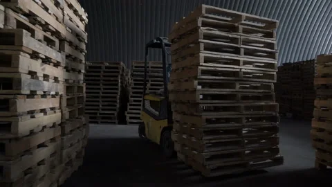 Worker is driving the elecric forklift. Loader and wooden pallet with boxes when Stock Footage 163434679