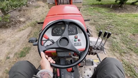 Worker driving tractor through cherry orchard, Central Otago, New Zealand. Stock Footage 342664374