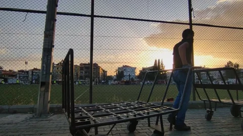 A worker is driving two trolley carts Stock Footage 196342621