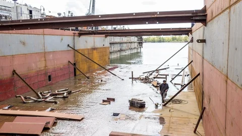The worker is in the dry dock of the shipyard. Stock Footage 86255088