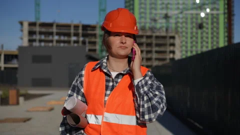 Worker Effectively Communicating on the Work Site Using Their Device Stock Footage 311860741