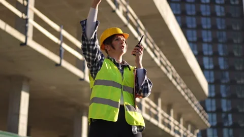 Worker Efficiently Managing and Overseeing Project Developments on Site Stock Footage 311862992