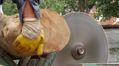 Worker at electric circular saw scraping logs, firewood for heating, close up. Stock Footage 55878237