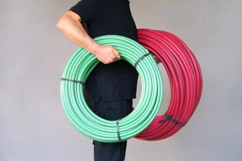 Worker with electrical protective tube Stock Photos