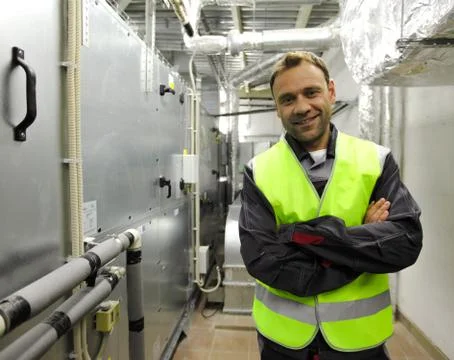 Worker in electrical switchgear room Stock Photos