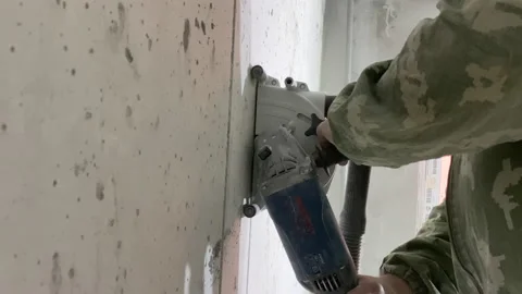 Worker electrician chasing concrete wall builder equipment construction site Stock Footage 150175455