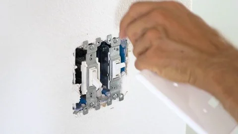 Worker electrician repair an electrical switch in apartment Stock Footage 71836679