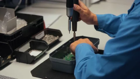Worker in electronics manufacturing soldering a component Stock Footage 142830399