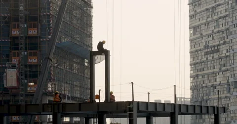 Worker elevated in construction site at Sunset Видео 224342110
