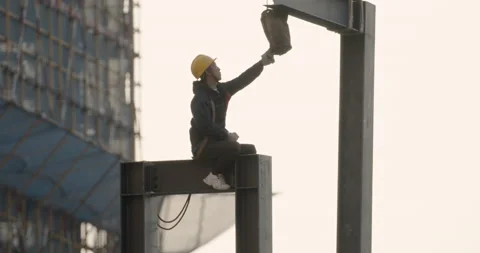 Worker elevated in construction site at Sunset CU2 Stock Footage 224345191