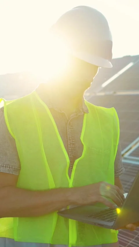 A Worker Engaged with a Laptop on a Construction Site While Wearing Essential Stock Footage 314206315