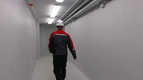 Worker engineer walks along the corridor of the factory Stock Footage 145807156