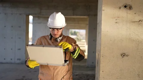 A worker engineer in a white helmet and uniform inspects the quality scanning of Stock Footage 235811275