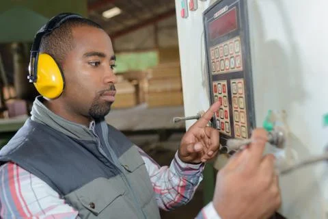 Worker entering code on keypad Stock Photos