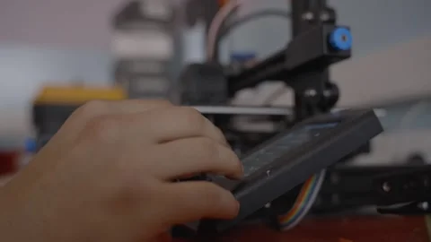 Worker Entering Commands on 3D Printer Touchscreen Stock Footage 321546915