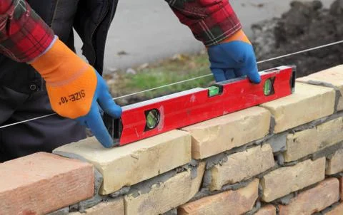 Worker examining brick wall Stock Photos