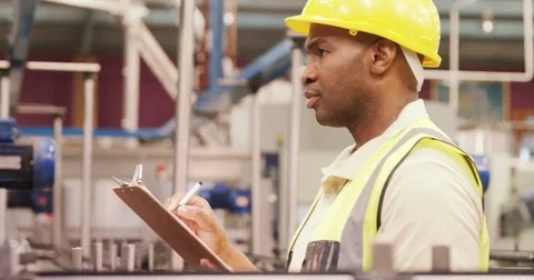 Worker examining while writing on clipboard Stock-Footage 72937060