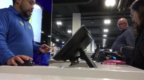 Worker explaining product delay reason for customer inside store Stock Footage 68989042