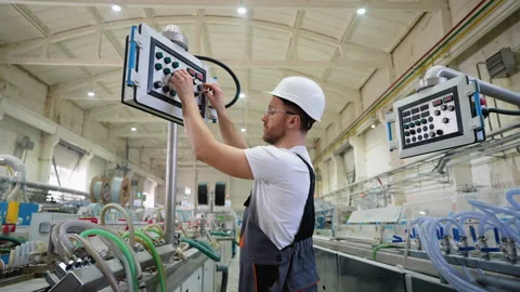 Worker On Factory Analyzes The Production Process And Programming Industrial CNC Stock Footage 270105975