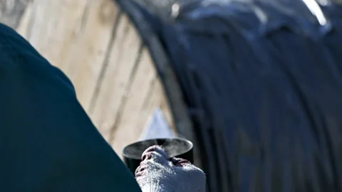 A worker at the factory in the break drinking coffee on a winter day 스톡 동영상 120258390