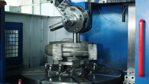 A worker at the factory makes a large spare part. Large lathe Stock Footage 125605586