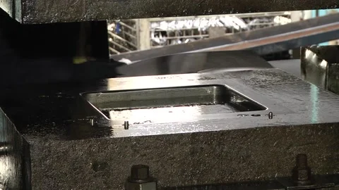 Worker in factory at metal skip machine putting work piece in Video stock 96392941