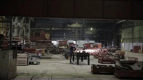 Worker at the factory processes metal, sparks fly Stock Footage 73759146