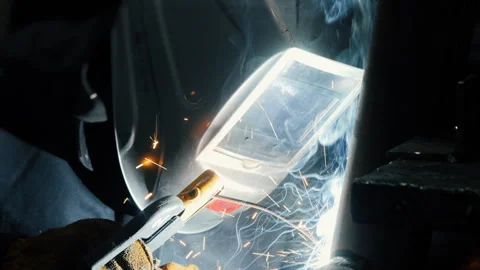 A worker at a factory in a protective mask welds a metal structure. Stock-Footage 306540987