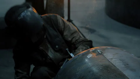 A worker at a factory in a protective mask welds a metal structure. Stock-Footage 306541121