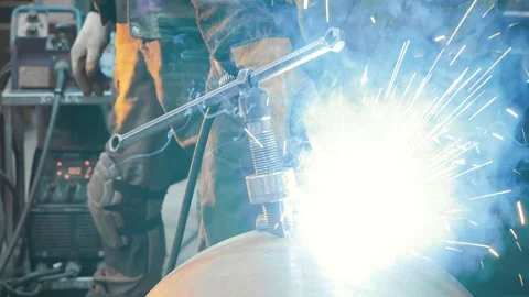 A worker at a factory in a protective mask welds a metal structure. Stock Footage 306541691