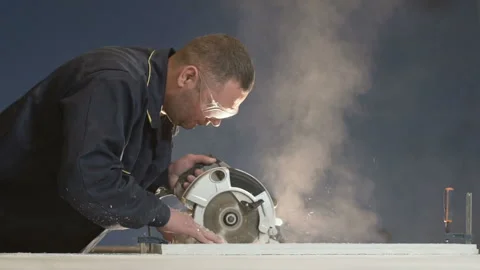 Worker at the Factory Regulates a Piece of Wood and Sawdust Fly Side Slowmotion Stock Footage 93851053