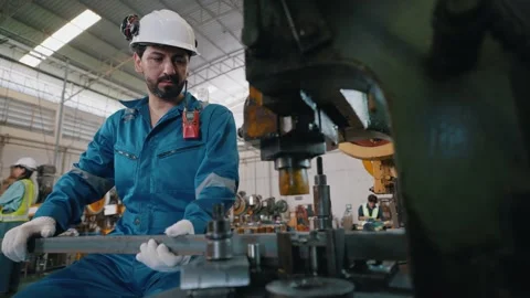 Worker in factory wears hard hat and gloves Stock Footage 338066257