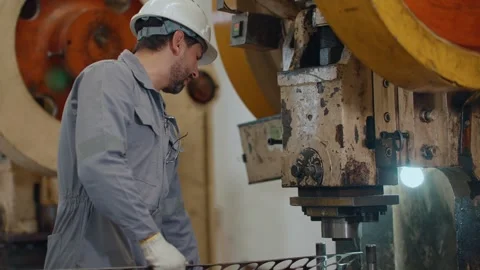 Worker in factory wears hard hat and gloves Stock Footage 338432809