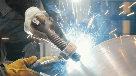 A worker at a factory welds a metal structure. Stock Footage 313100108