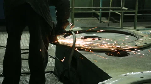 Worker at a factory working with a grinding machine Stock Footage 100332829