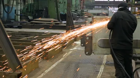 Worker at a factory working with a grinding machine Stock Footage 100607121
