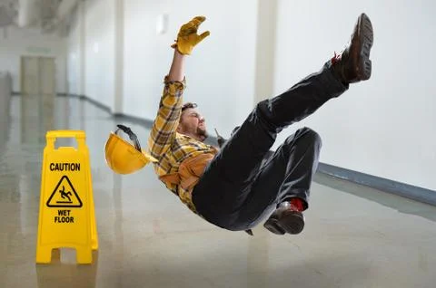 Worker Falling on Wet Floor Stock Photos
