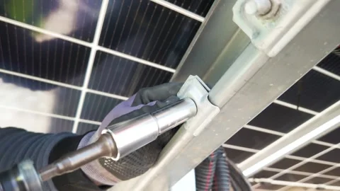 Worker Fastening Metal Base with Electric Screwdriver at Solar Farm Stock Footage 337953502