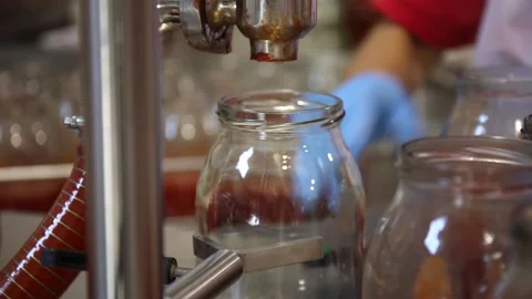 Worker fill the jars with tomato juice Stock Footage 130904961
