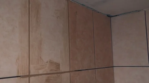 Worker fills the seams of tile Stock Footage 89580419