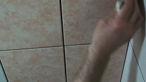 Worker fills the seams of tile Stock Footage 89580496