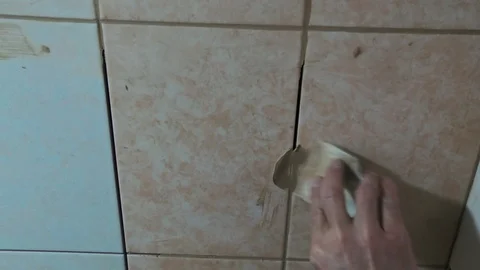 Worker fills the seams of tile Stock Footage 89580595