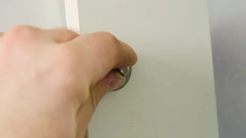 Worker finishes attaching small metal object to surface Stock Footage 316186953