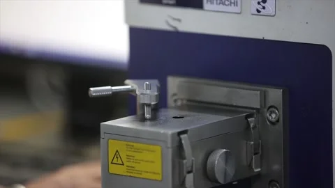 Worker is fitting the metal sample in the hardness testing machine in lab  스톡 동영상 305996426