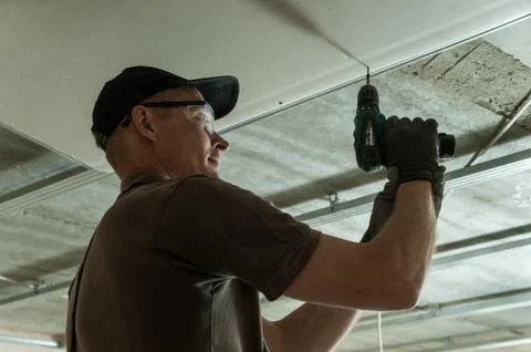 Worker fixes the drywall Stock Photos