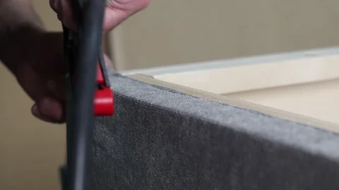 Worker fixes the fabric with a pneumatic stapler in the factory shop. Video stock 171004181