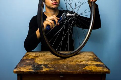 Worker fixing bicycle tyre Фото