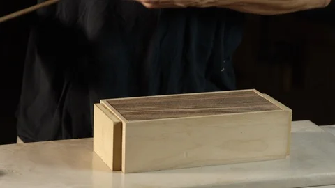 Worker fixing a C-Clamp over the wooden box Stock Footage 104221847