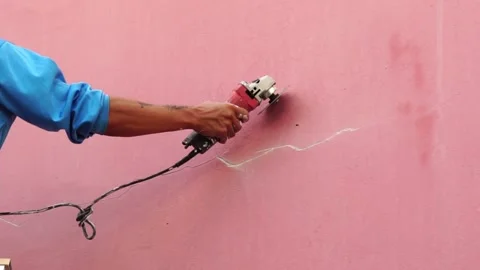 Worker fixing cracks on wall, spreading plaster using trowel, Repair cracked wal Stock Footage 232216251