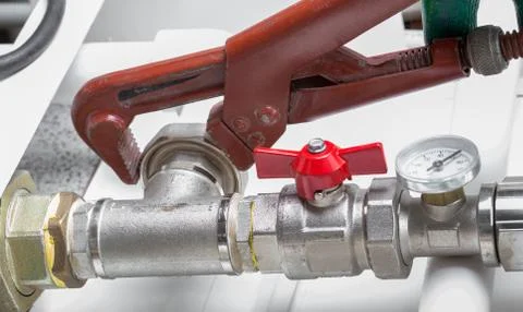 Worker fixing heating system, close up photo Stock Photos